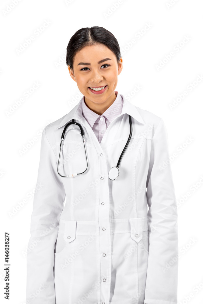 asian female doctor standing with stethoscope in white coat isolated on white