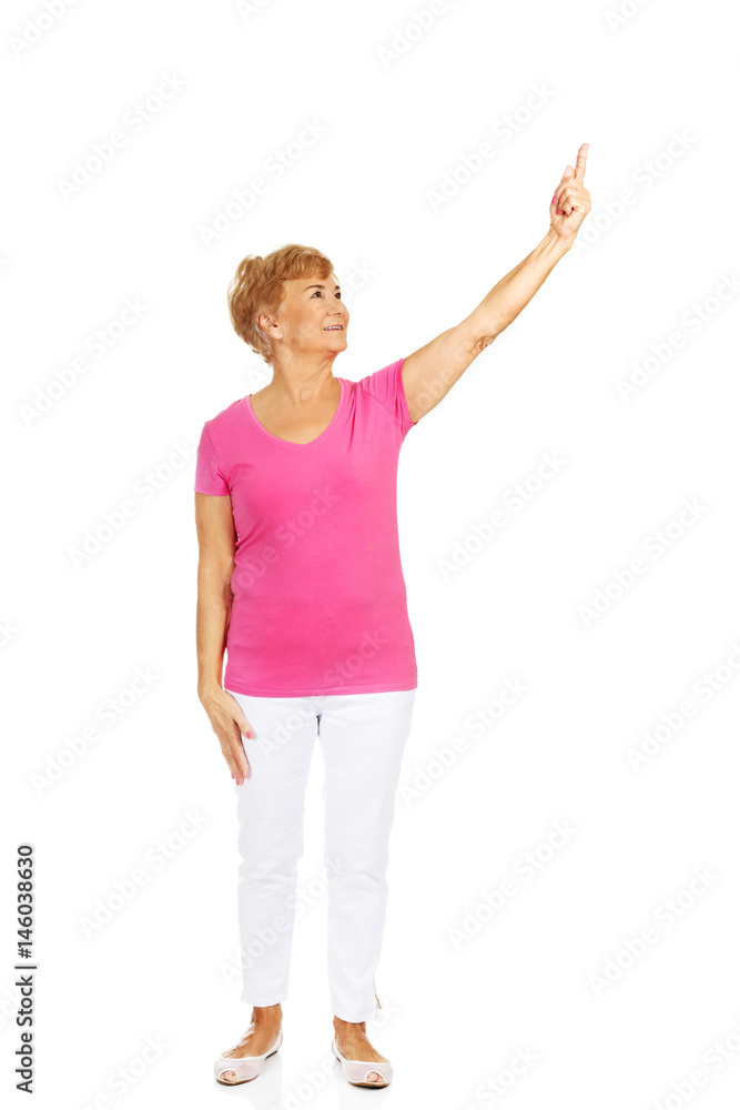 Smile elderly woman pointing for copyspace or something Smile elderly woman pointing for copyspace or something