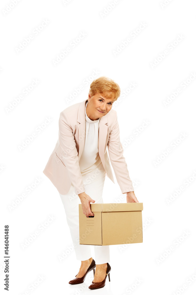 Smile elderly business woman holding cardboard box Smile elderly business woman holding cardboard box