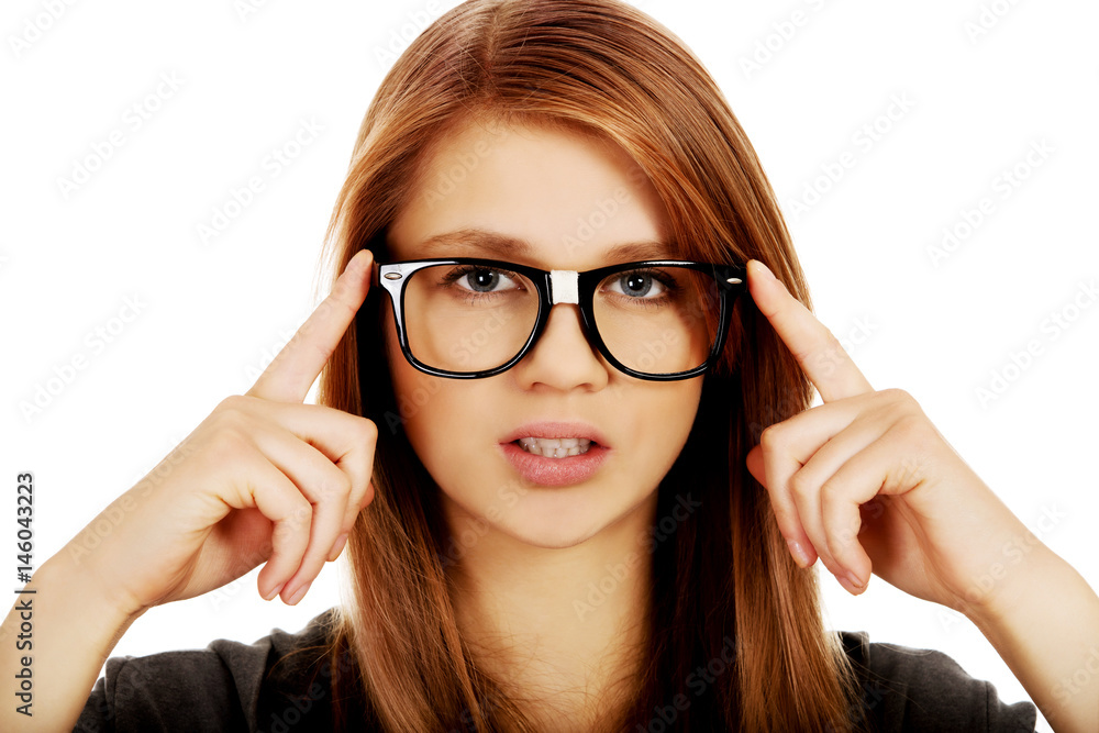 Pretty teenage woman improving glasses Pretty teenage woman improving glasses
