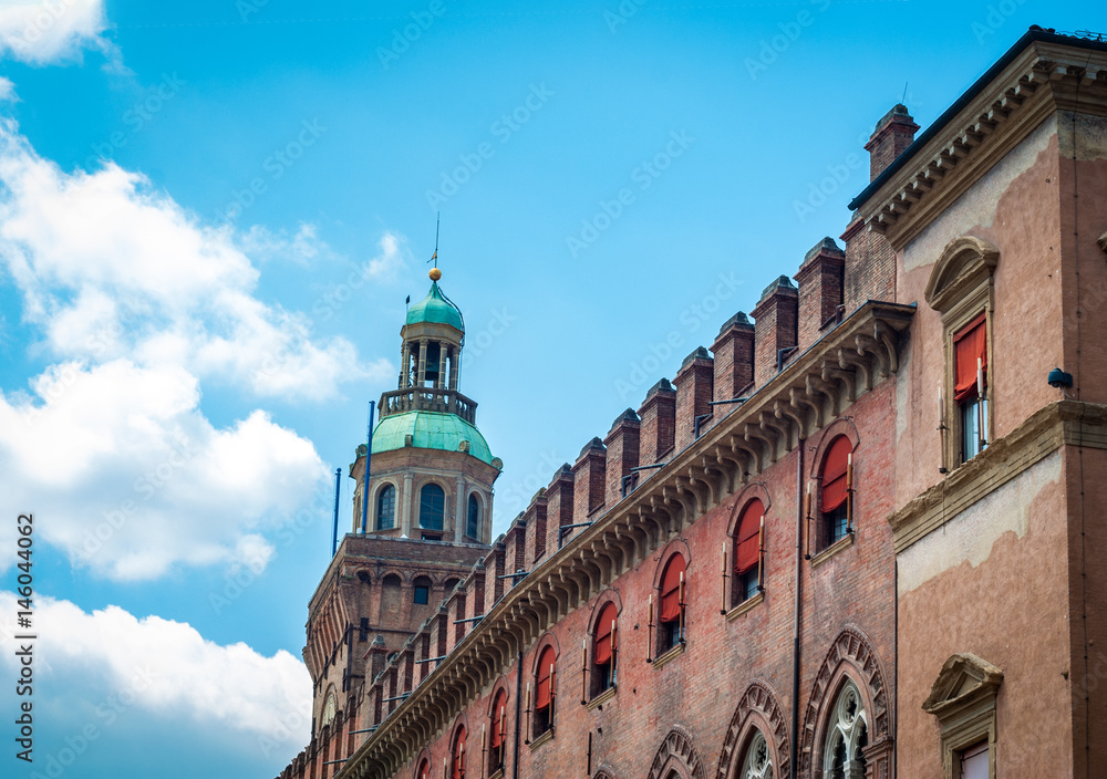 Piazza Maggiore in Bologna old town tower of hall with big clock and blue sky