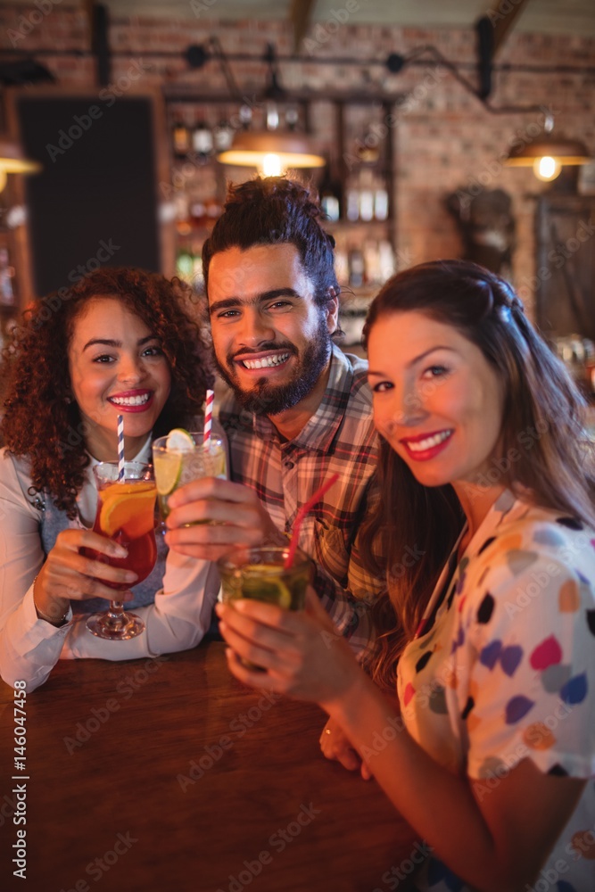 Portrait of young friends having drinks