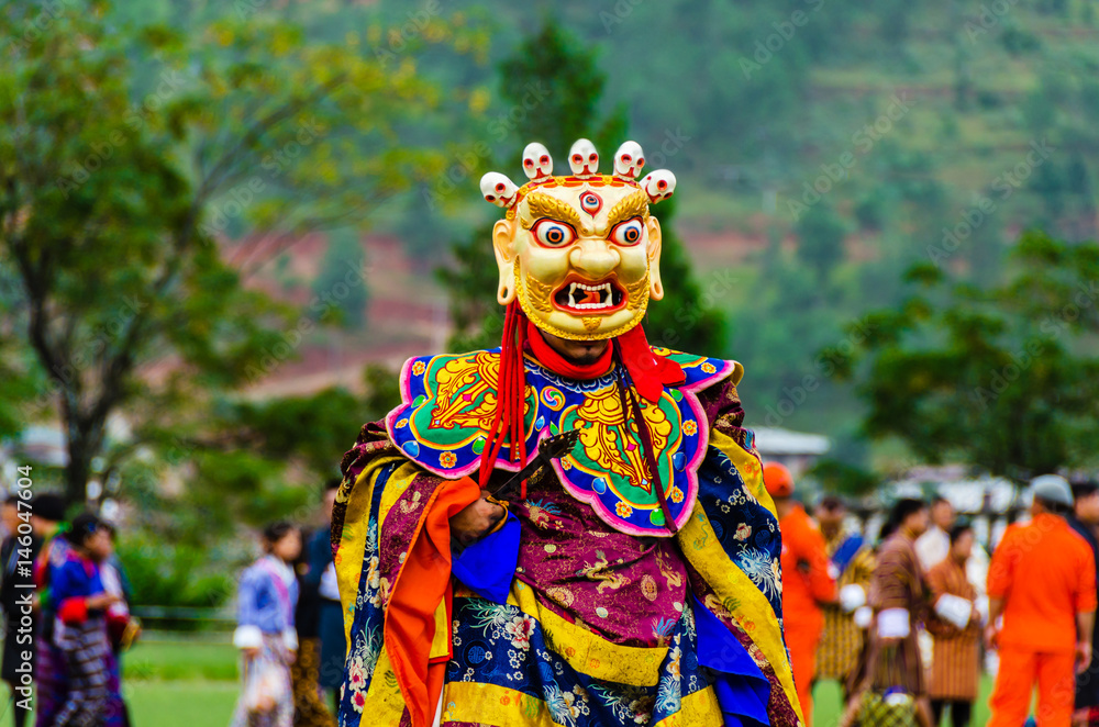 Bhutan, masked dancer at a traditional monastery festival the Wangdue Phodrang Tsechu
A monk in a colorful dress with mask during the tsechu (dance festival) in Wangdue, Bhutan. 
