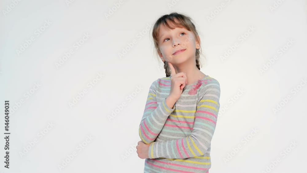 Thinking little girl standing with finger on chin looking away at blank copy space, locked down real time video Thinking little girl standing with finger on chin looking away at blank copy space, locked down real time video