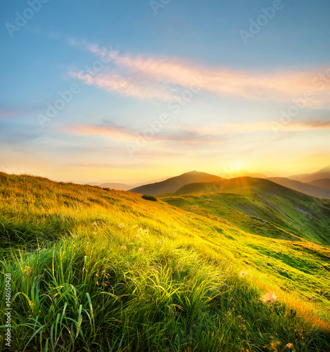 Mountain field during sunset. Beautiful natural landscape