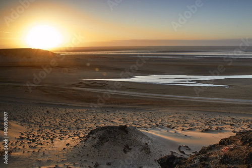 Sunrise in the desert by the sea