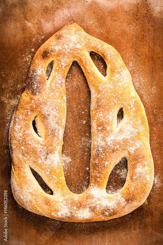 Freshly baked fougasse top view. Traditional French wheat bread closeup