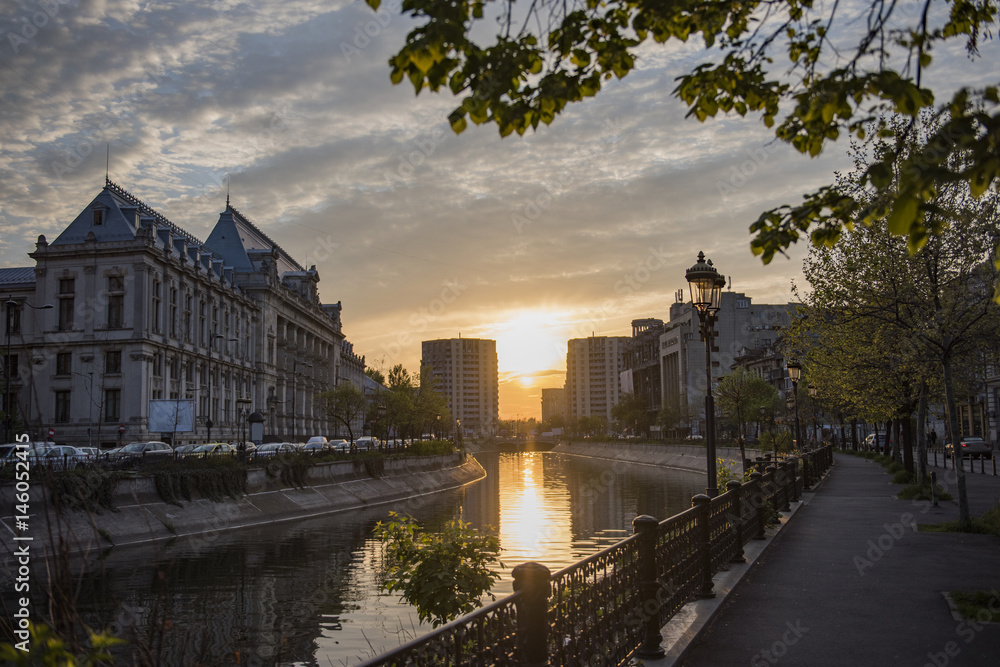 Bucharest city center at sunset - Justic Palace and Dimbovita river.