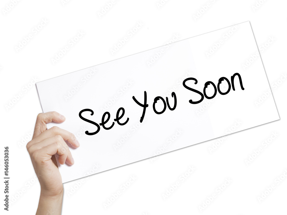 See You Soon Sign on white paper. Man Hand Holding Paper with text. Isolated on white background. See You Soon Sign on white paper. Man Hand Holding Paper with text. Isolated on white background.