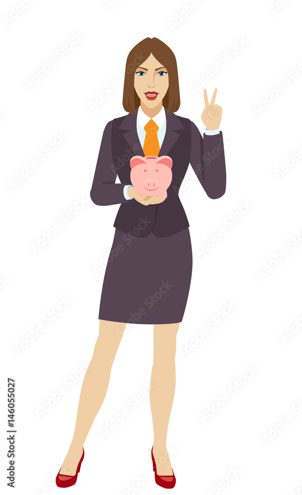 Businesswoman holding a piggy bank and showing victory sign Businesswoman holding a piggy bank and showing victory sign