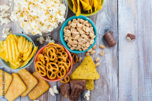 Fotografia Unhealthy snacks on wooden background