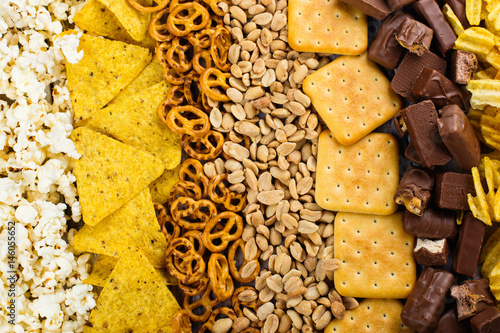 Unhealthy snacks on wooden background photo