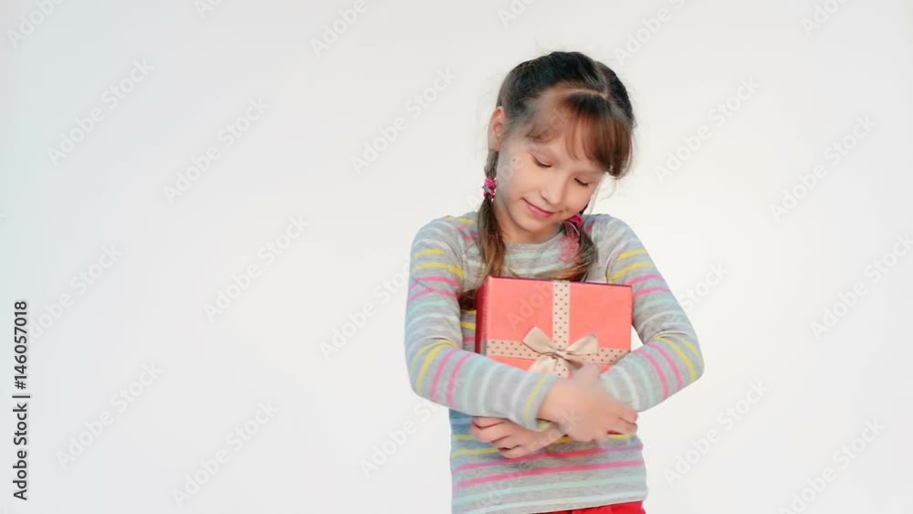 Little girl embracing red gift box, locked down real time video Little girl embracing red gift box, locked down real time video