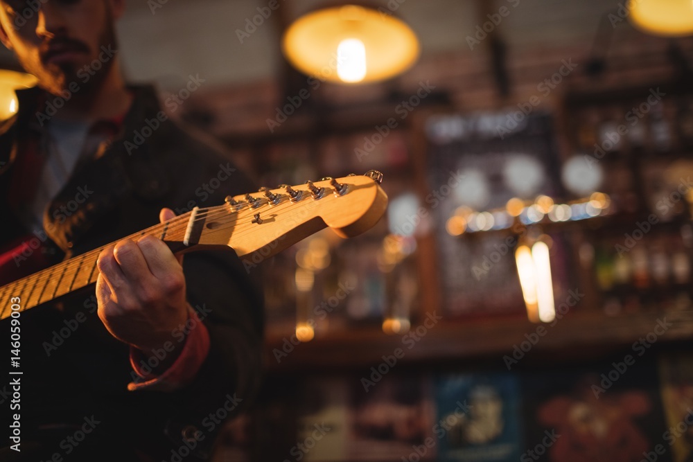 Fototapeta premium Young man playing guitar 