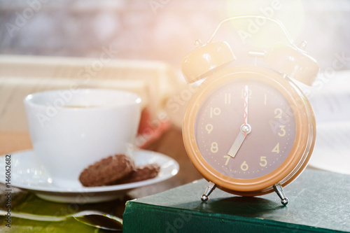 coffee cup and clock on old wood table