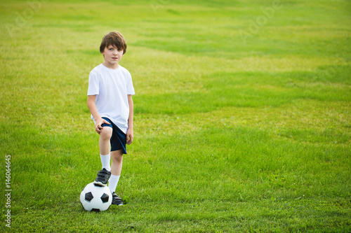 Boy with a soccer ball on a soccer field. © BestForYou