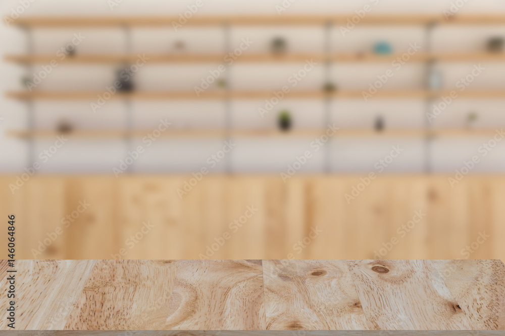 restaurant or coffee shop blur background with selected focus wood table for montage or display your product