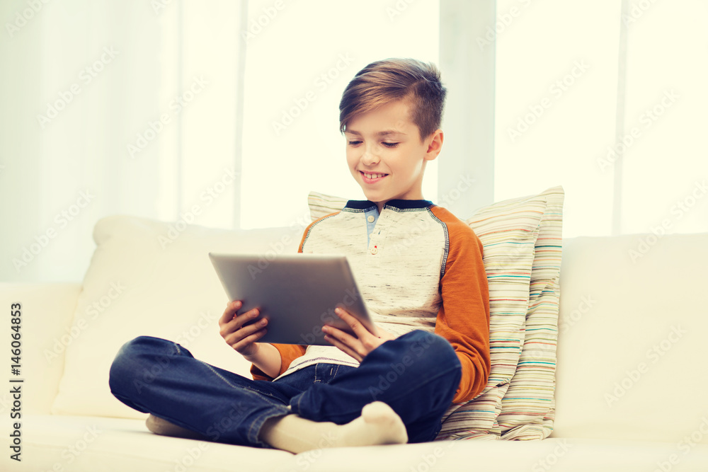 smiling boy with tablet computer at home smiling boy with tablet computer at home
