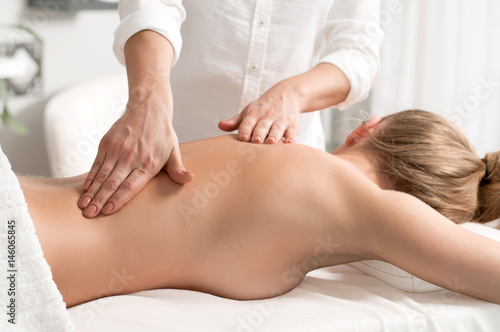 Woman having massage of body in the spa salon.