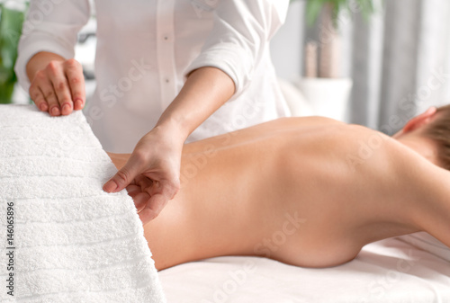 Woman having massage of body in the spa salon.