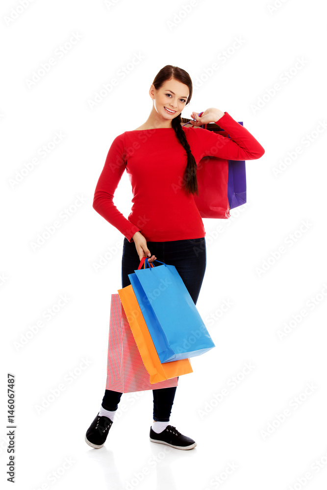 Young happy smiling woman holding shopping bags Young happy smiling woman holding shopping bags