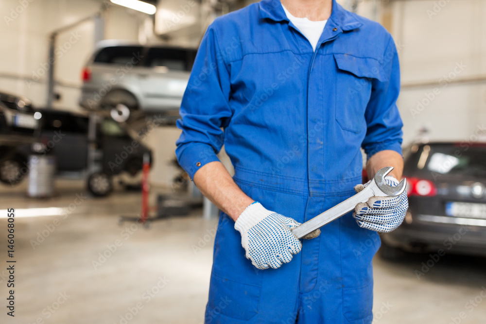 auto mechanic or smith with wrench at car workshop auto mechanic or smith with wrench at car workshop