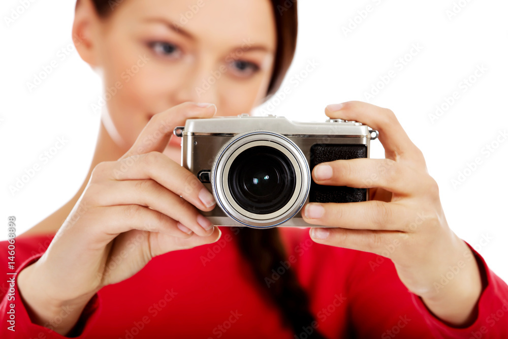 Pretty woman taking a photo using classic slr camera Pretty woman taking a photo using classic slr camera