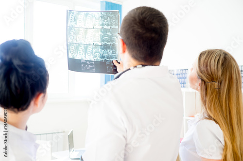 Group of doctors looking at xray