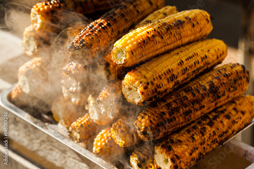 Fresh roasted or grilled corncobs. Grilled Corn for sale on the street. photo