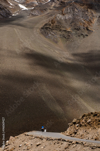 man is riding bicylcle on Manali-Leh highway. Himachal Pradesh, India photo