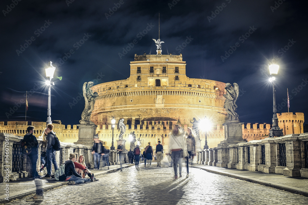 Naklejka premium ITALY - ROME - APRIL 26 2017- Girls are sitting on the ground talking each other. Rome April 26 Castel Sant'Angelo is a museum and art gallery in the heart of Rome.