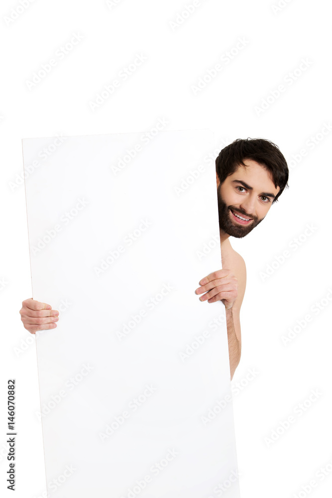Young shirtless man holding empty banner.