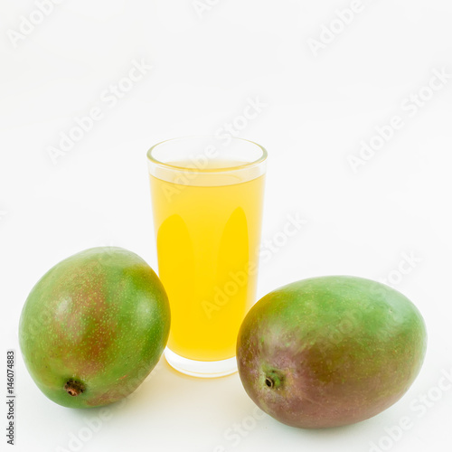 Fresh juice and mango fruits on white background. Flat lay, top view.
