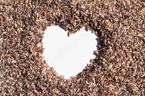 Whole grain rice in Heart Shape space Background © ukrit