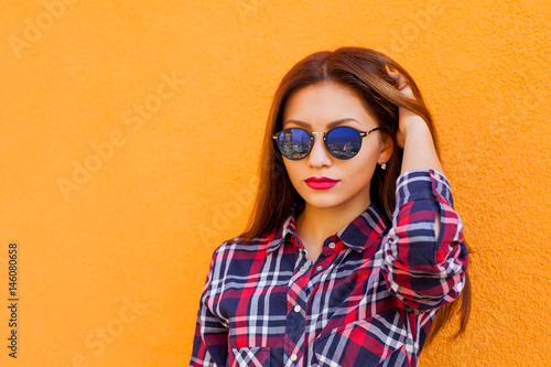 Wallpaper Mural Closeup portrait of beautiful women with perfect make-up and sunglasses  reflection, smiling. Concept target, dream. Archive a goal. Orange background Torontodigital.ca