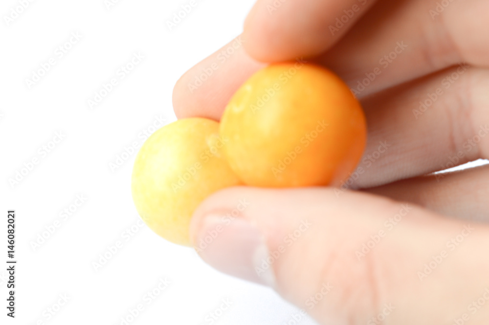 hand holding orane gum isolated on white hand holding orane gum isolated on white