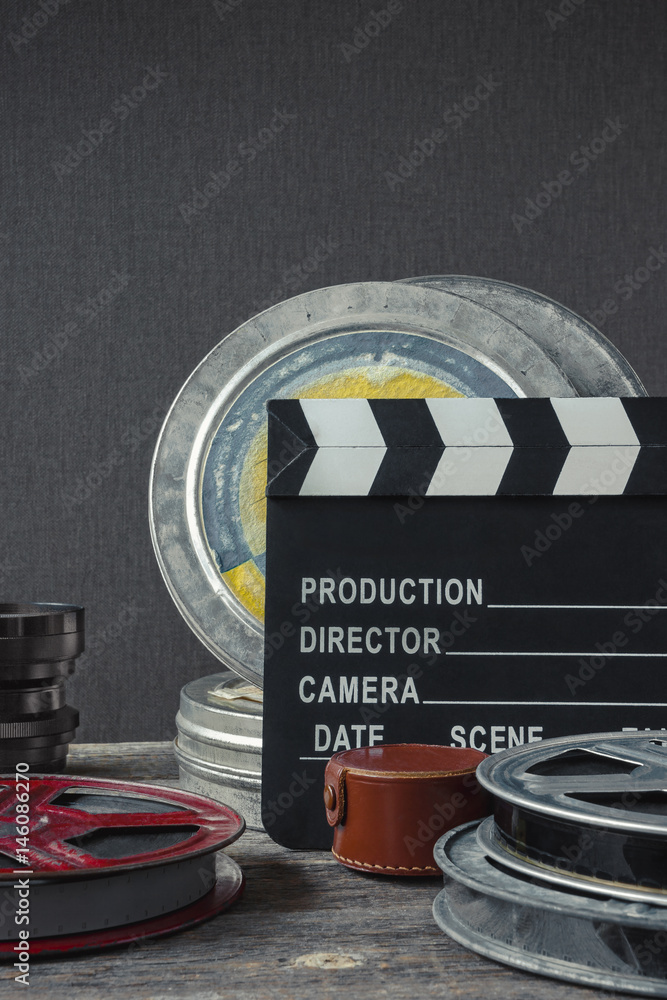 Fototapeta premium Clapperboard, a box of film and lens