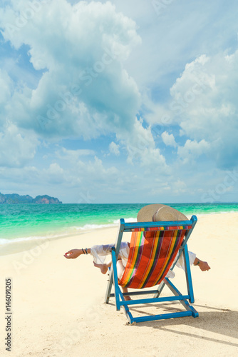 Woman at beautiful beach on a sunbed © Netfalls