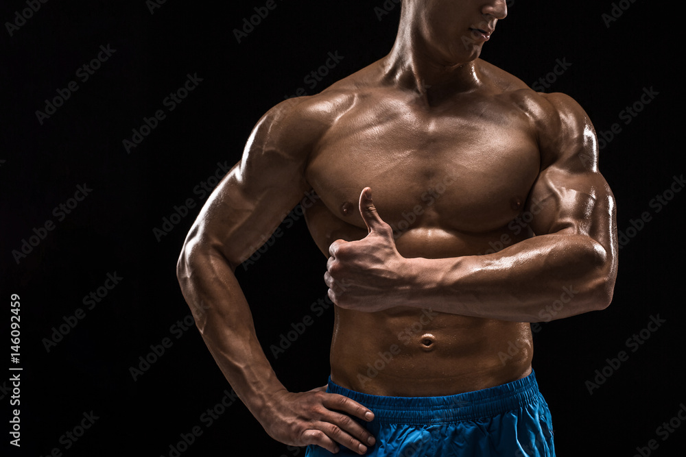 Fototapeta premium Part of a man's body on a dark background with copyspace