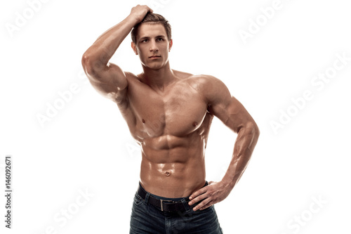 Muscular handsome young man with naked torso. Isolated on white background.