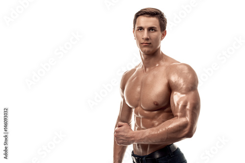 Muscular handsome young man with naked torso. Isolated on white background. Copy space