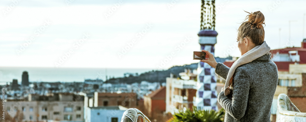 Fototapeta premium tourist woman in Barcelona taking photo with digital camera