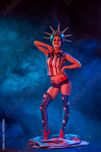 Young woman in stage costume of striptease dancer posing