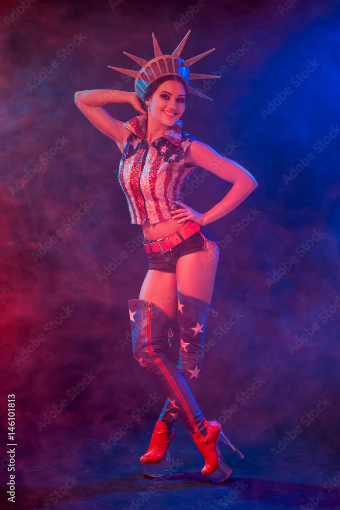 Young woman in stage costume of striptease dancer posing