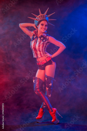 Young woman in stage costume of striptease dancer posing