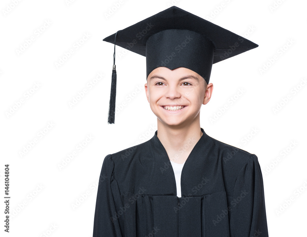 Portrait of a graduate teen boy student in a black graduation gown with hat - isolated on white background. Child back to school and educational concept. Portrait of a graduate teen boy student in a black graduation gown with hat - isolated on white background. Child back to school and educational concept.