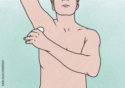 Midsection of man applying deodorant under armpit against colored background