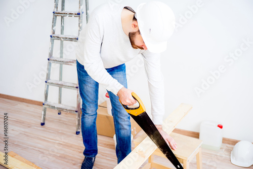 Carpenter with a handsaw