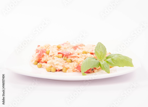 Risotto with tomato and pea on a white background