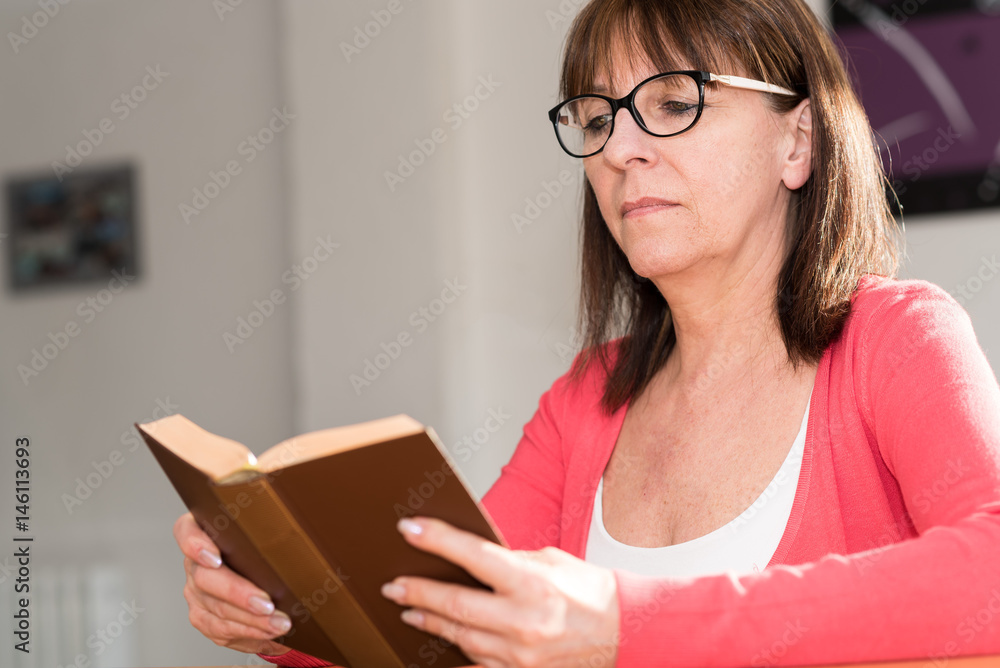 Mature woman reading a book Mature woman reading a book